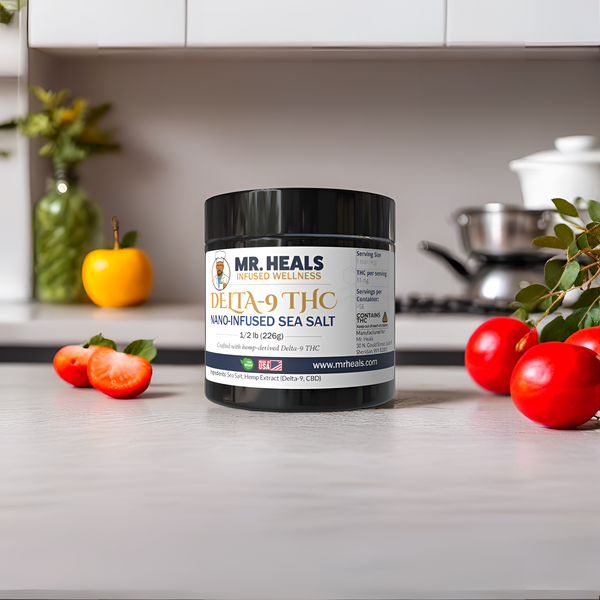 Jar of Mr. Heals Delta-9 THC nano-infused sea salt on a kitchen counter with tomatoes and a plant.