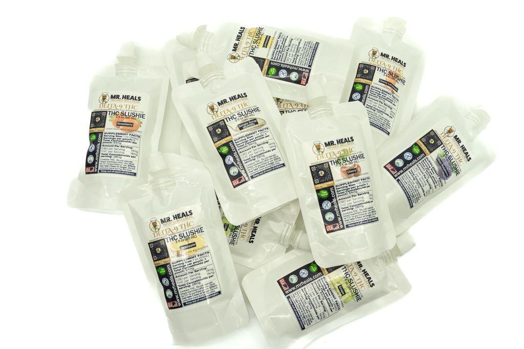 Multiple packages of Mr. Heals THC Slushies lying flat on a white background