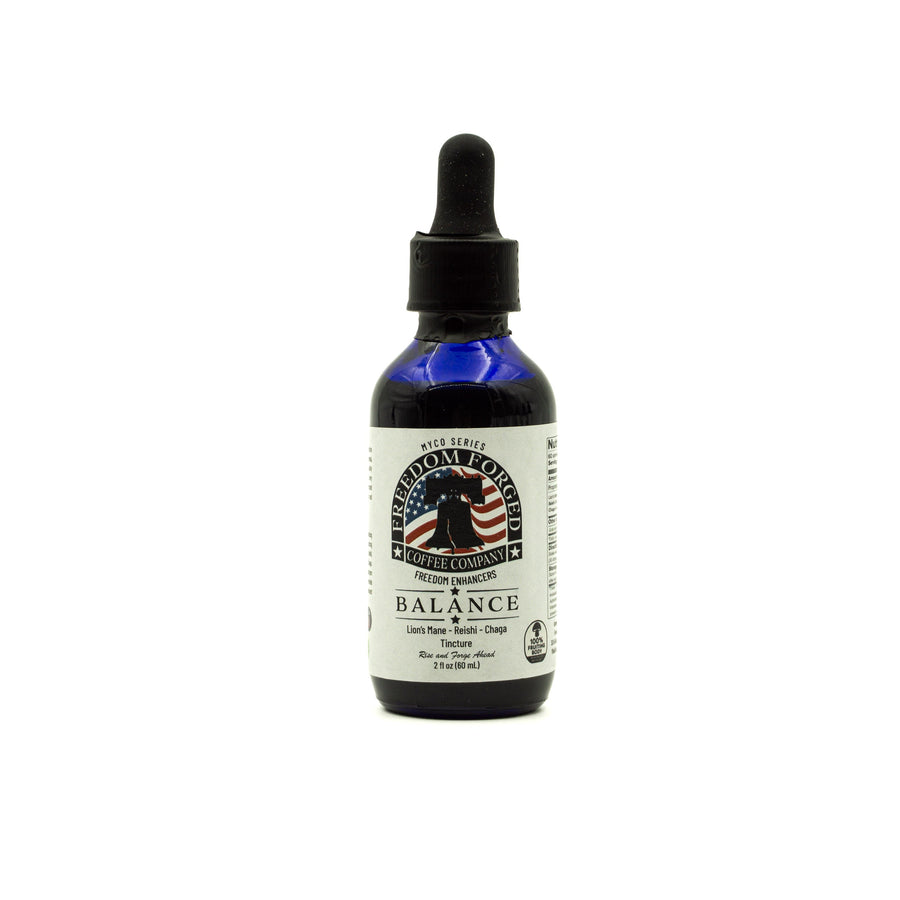 Bottle of 'Balance' mushroom tincture with a dropper on a white background