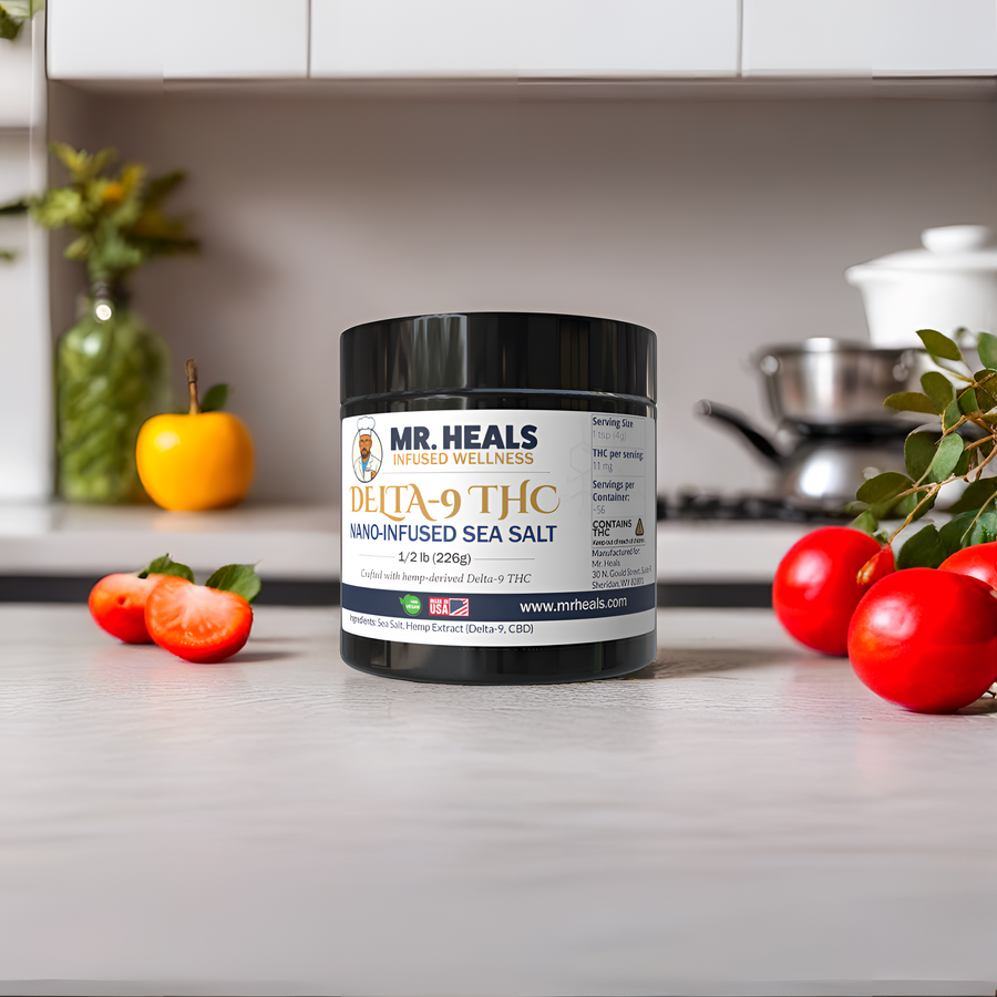Jar of Mr. Heals Delta-9 THC nano-infused sea salt on a kitchen counter with tomatoes and a plant.