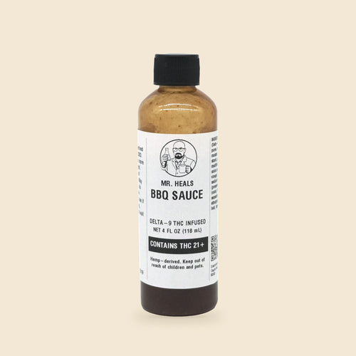 Mr. Heals Delta-9 THC BBQ Sauce, 4 fl oz bottle on parchment background