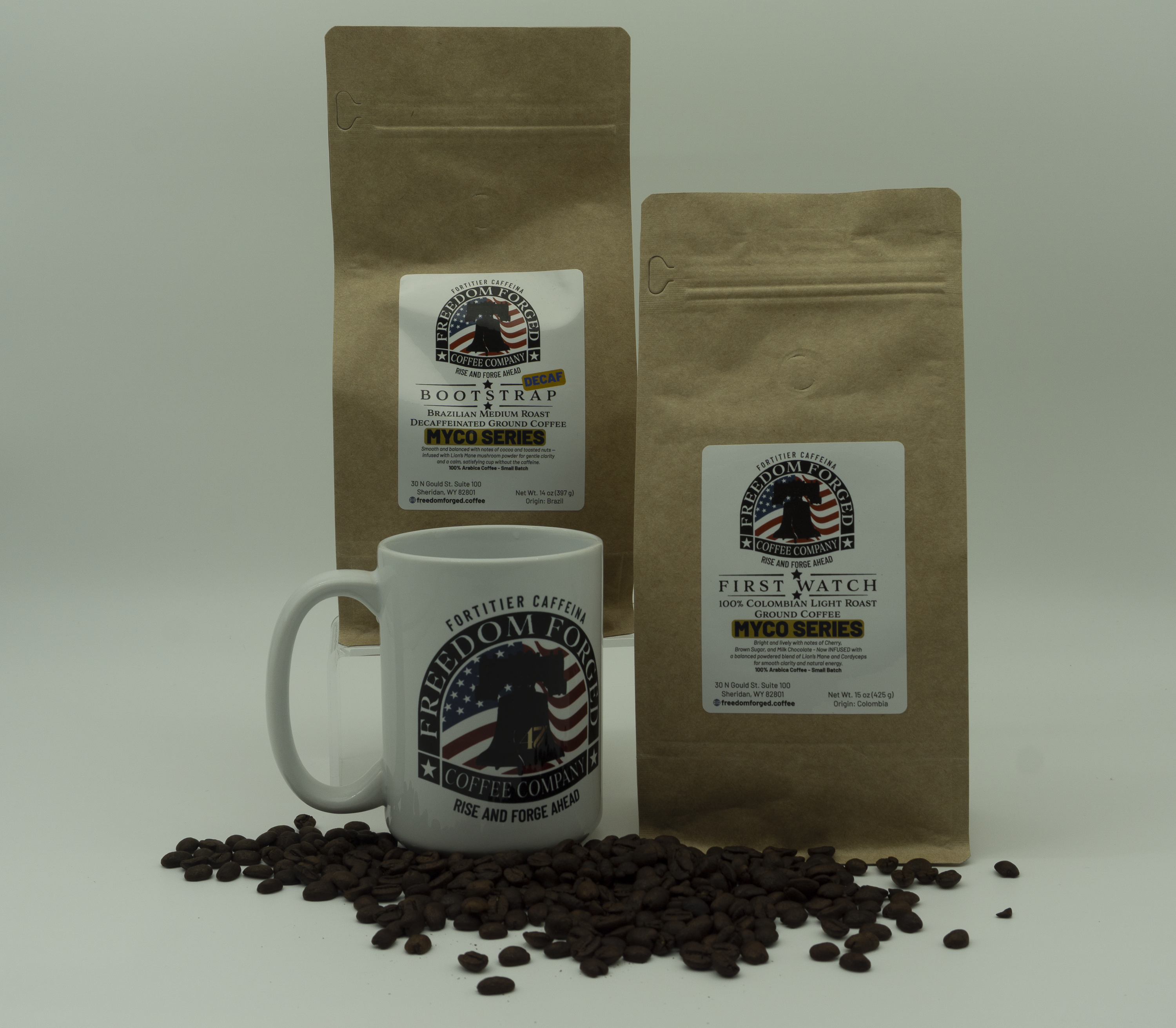 Two brown coffee bags and a white mug with coffee beans on a light gray background